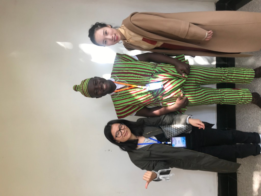 Ghanaian college student standing with two Chinese classmates